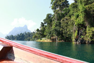 Scenic view of lake by trees against sky