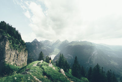 Scenic view of mountains against cloudy sky