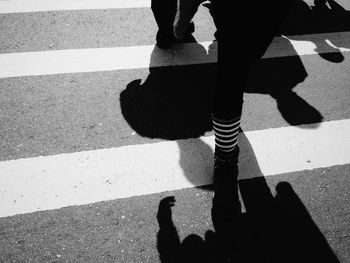 Shadow of people on road