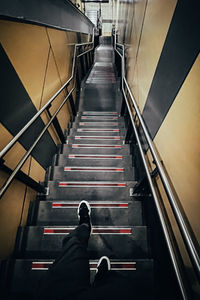 Low section of person on escalator at subway station