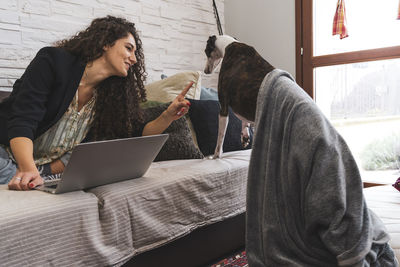 Young woman using laptop at home