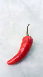 Close-up of red chili peppers on table