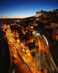 High angle view of illuminated street amidst buildings in city