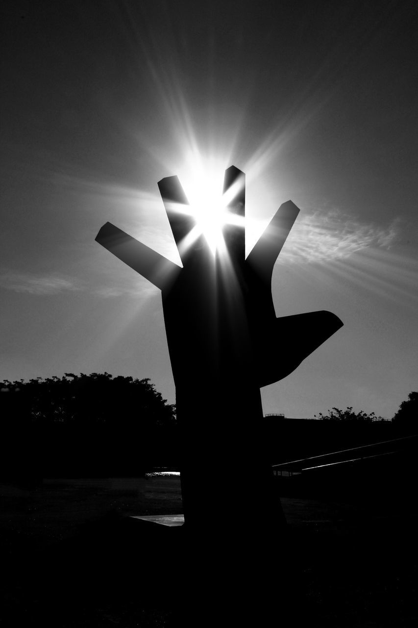 sun, silhouette, sunbeam, sunlight, sky, lens flare, back lit, low angle view, sunset, outdoors, tree, nature, spirituality, tranquility, religion, no people, part of, sunny, cross