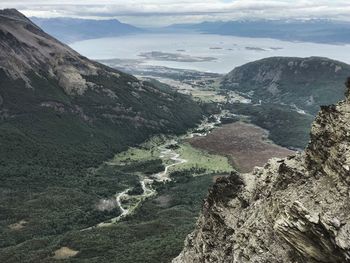 High angle view of valley and mountains against sky