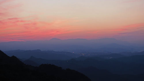 Scenic view of silhouette mountains against sky during sunset