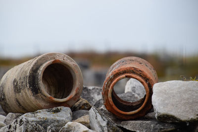 Close-up of rusty pipe on rock