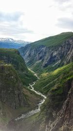 Scenic view of mountains against cloudy sky