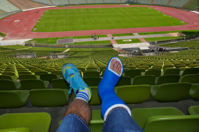 Low section of man with broken leg at stadium