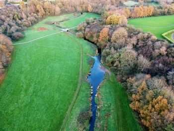 High angle view of river amidst trees against sky