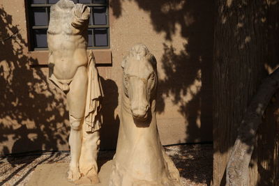 Statue against building