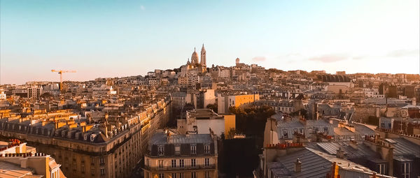 High angle view of city buildings against clear sky