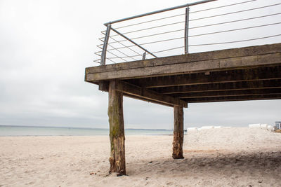 Low angle view of lifeguard hut on beach against sky