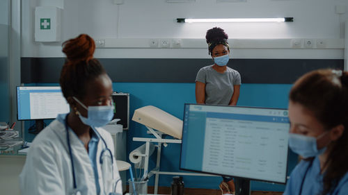 Doctor wearing mask with patient at hospital