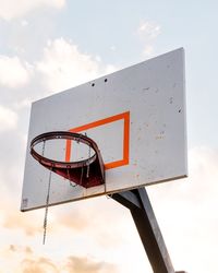 Low angle view of broken basketball hoop against sky