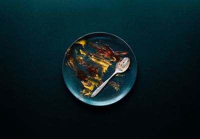 Directly above shot of breakfast empty dirty plate on black background