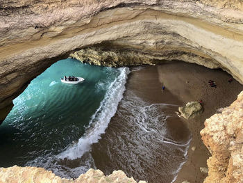 A cave on the beach with a boat at summer