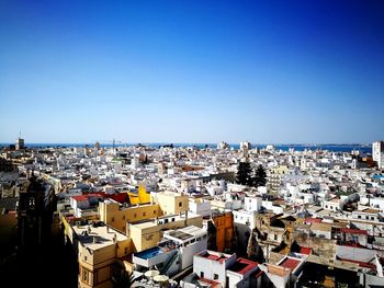 High angle view of townscape against blue sky