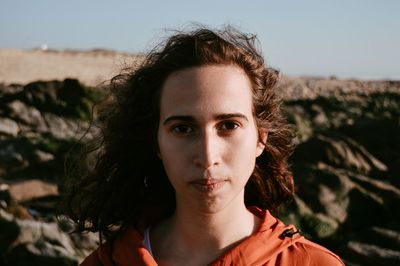 Close-up portrait of young woman against clear sky