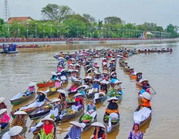 High angle view of people on river against trees