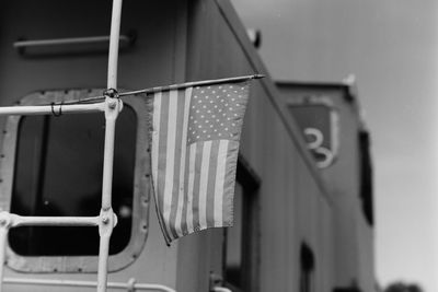 Close-up of american flag hanging on train