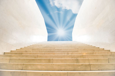 Sun shining on sky on marble staircase with stairs in abstract architecture. religious concept