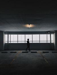 Side view of silhouette man walking in corridor