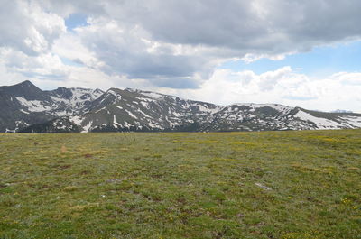 Scenic view of mountains against cloudy sky