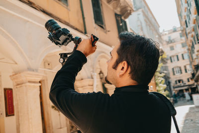 Rear view of man standing in city