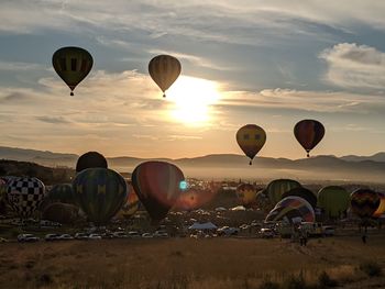 Hot air balloons flying over land