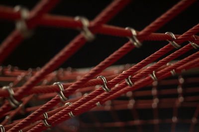 Close-up of rope tied to metal fence