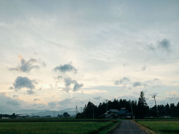 Scenic view of field against cloudy sky