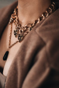 Golden chain hanging on a woman's neck. beautiful elegant luxury jewelry accessories