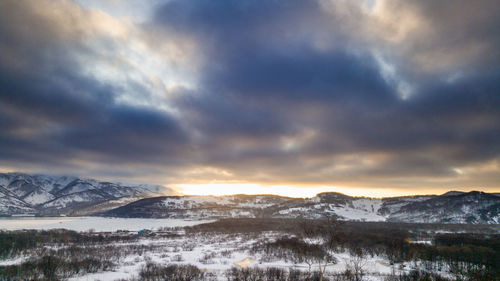 Scenic view of snowcapped mountains against sky during winter