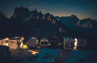 Panoramic view of illuminated mountains against sky at night