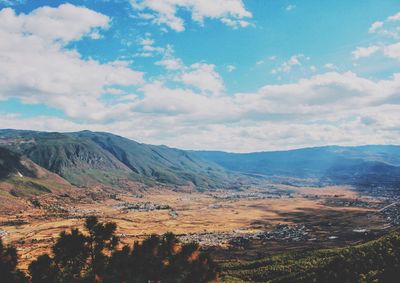 Scenic view of mountains against cloudy sky