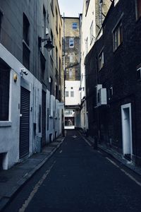 Empty alley amidst buildings in city