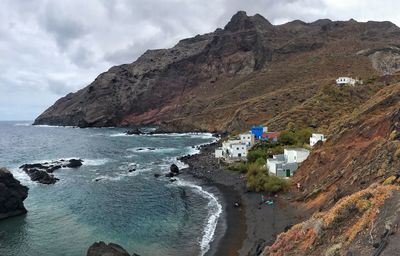 Panoramic view of sea and mountains against sky