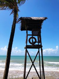 Lifeguard hut on beach against sky