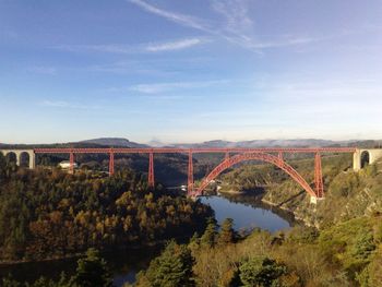 Garabit viaduct over river truyere against sky