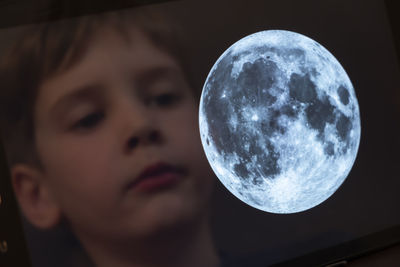 Close-up portrait of man against moon
