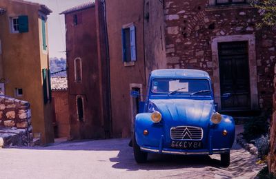 Car on street against buildings