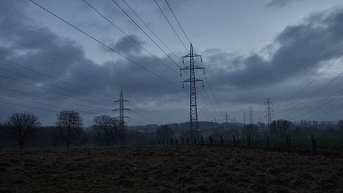 Low angle view of electricity pylon against sky