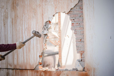 Man working on wood against wall