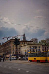 View of cityscape against cloudy sky