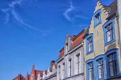 Low angle view of buildings against blue sky