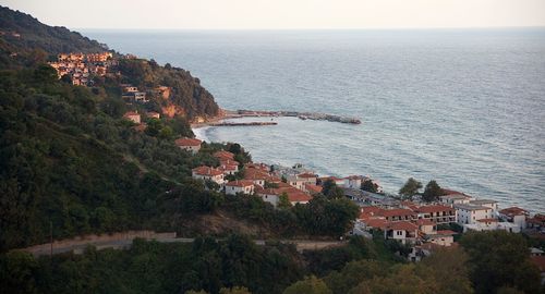 High angle view of buildings by sea against sky