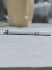 Close-up of cigarette on table