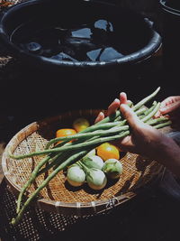 High angle view of person hand in basket