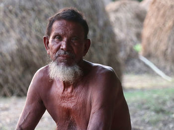 Portrait of old man standing on field